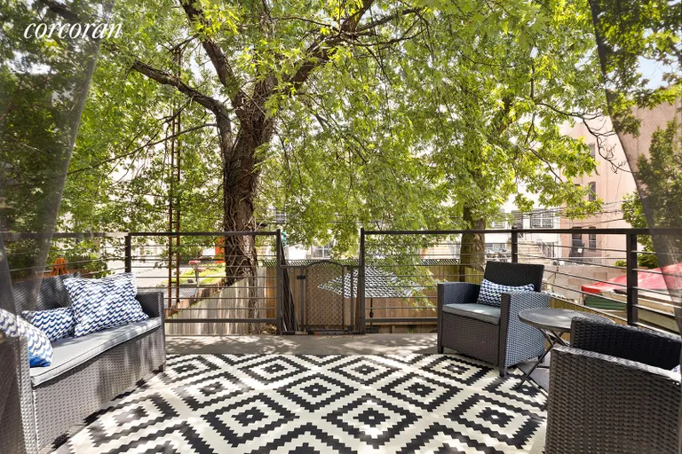 New York City Real Estate | View 1152 Halsey Street | Charming deck with lush tree views & garden below | View 5