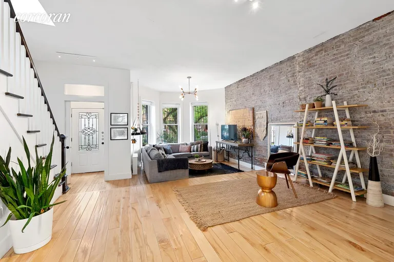 New York City Real Estate | View 970 St Johns Place | Sunken Living Room w. Exposed Brick Detail | View 4