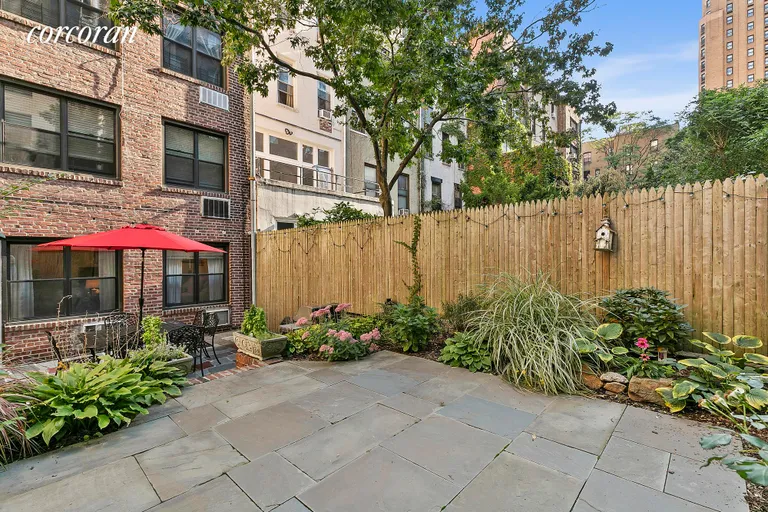 New York City Real Estate | View 336 East 50th Street, GARDENB | Garden with Building in the background | View 2