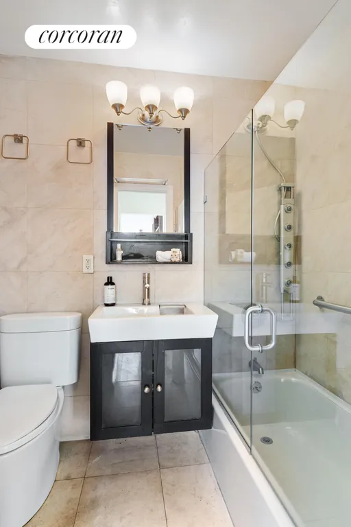 New York City Real Estate | View 382 Central Park West, 12F | Renovated bathroom with vanity & glass shower | View 5