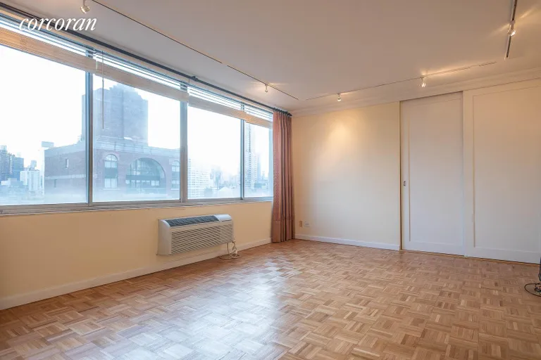 New York City Real Estate | View 353 East 72Nd Street, 24B | A diagonal of the living room with closet | View 6