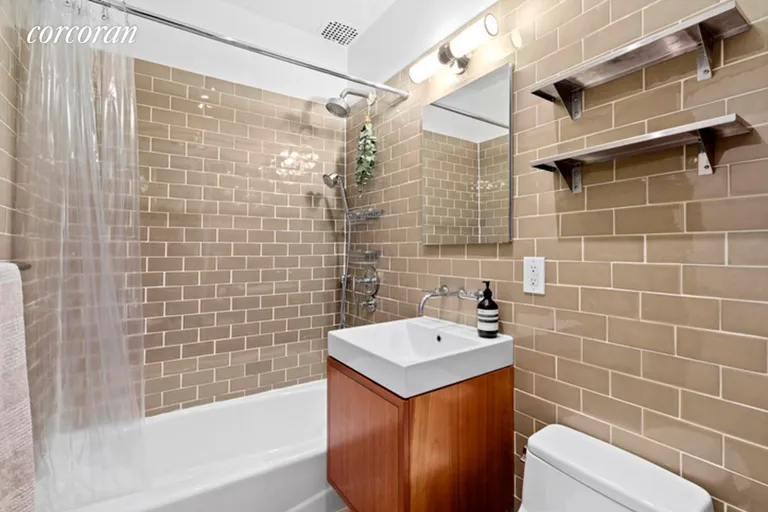 New York City Real Estate | View 460 West 23rd Street, GF | Bathroom with Vanity and Storage | View 5
