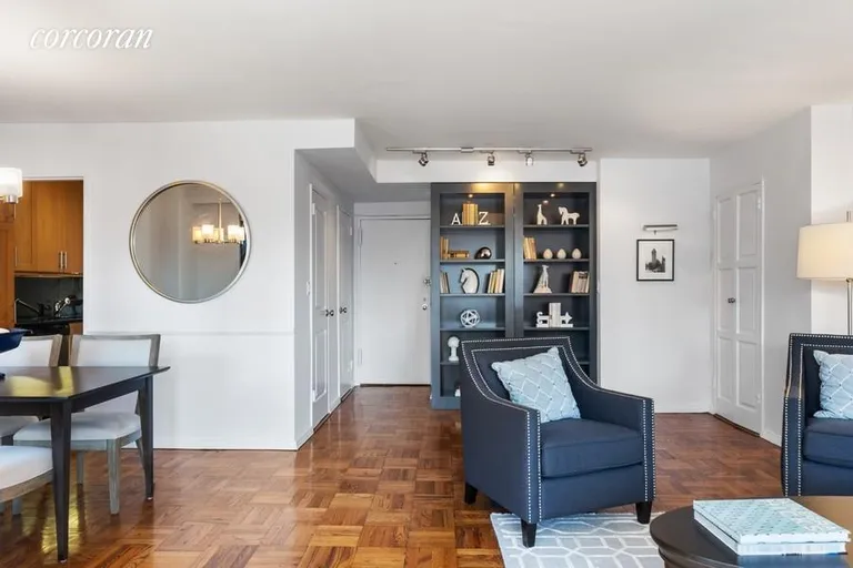 New York City Real Estate | View 175 East 74th Street, 16C | Entrance with Book Cases | View 4