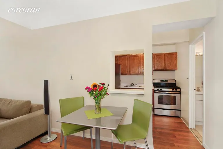 New York City Real Estate | View 77 Bleecker Street, 606 | Dining area next to kitchen with pass-thru window | View 3