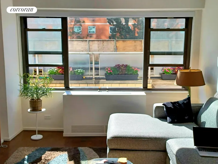 New York City Real Estate | View 115 East 9th Street, 2F | Living room window with flowers | View 12