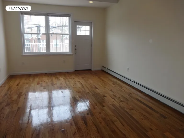 New York City Real Estate | View 2340 Matthews Avenue | Living room w/door to deck | View 4