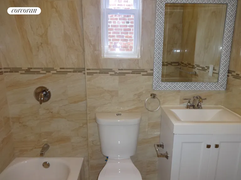 New York City Real Estate | View 2340 Matthews Avenue | fully tiled bath with window | View 11
