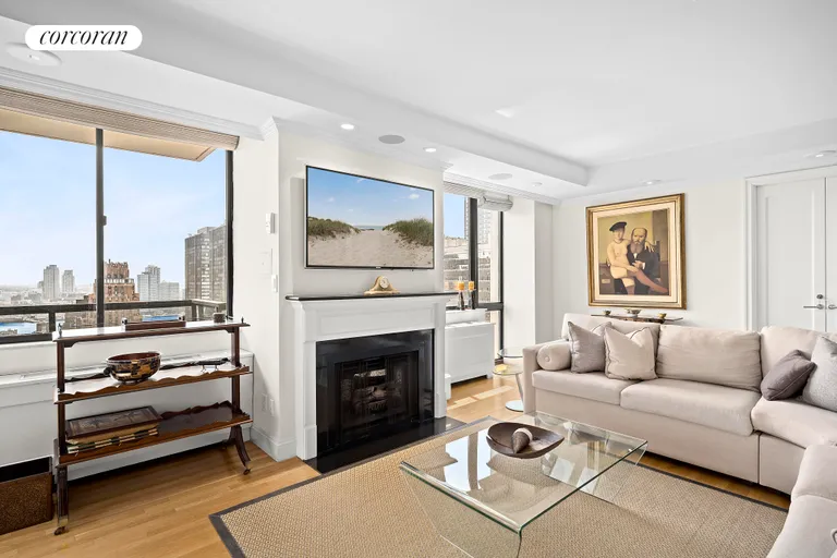 New York City Real Estate | View 255 East 49th Street, 30A | Living room with fireplace | View 2