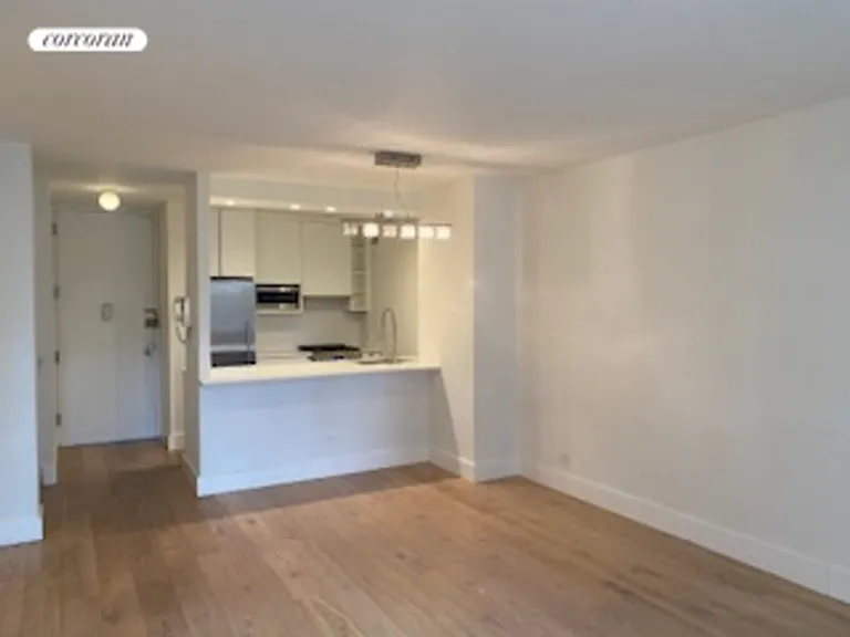 New York City Real Estate | View 30 West 61st Street, 11E | Open kitchen facing living room | View 2