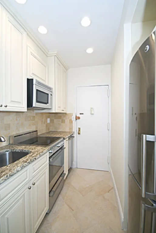 New York City Real Estate | View 140 West 69th Street, 82B | A Separate Kitchen | View 3