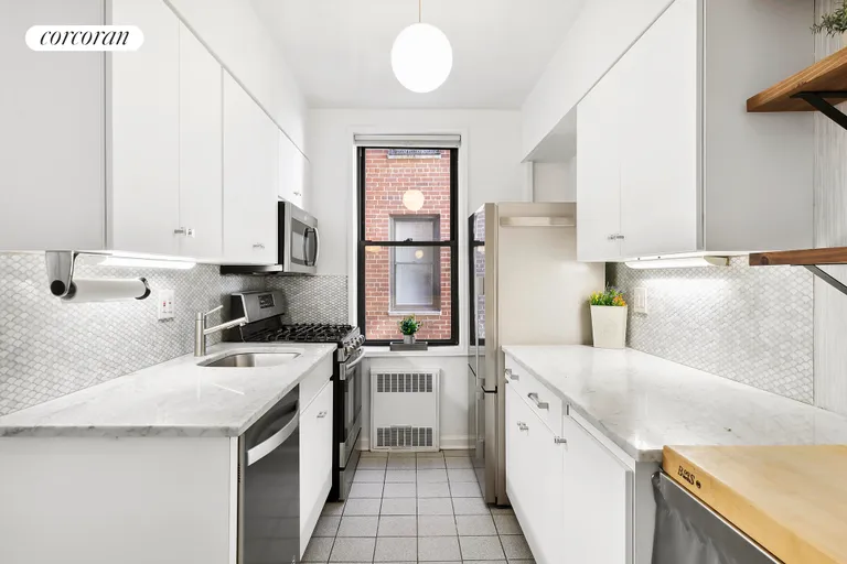New York City Real Estate | View 30 East 9th Street, 4B | Windowed Kitchen with Breakfast Bar | View 5