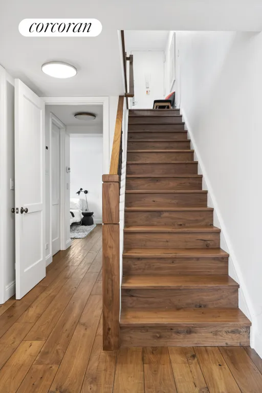 New York City Real Estate | View 531 Main Street, 706 | Stairs & Hallway to Primary Bedroom | View 11