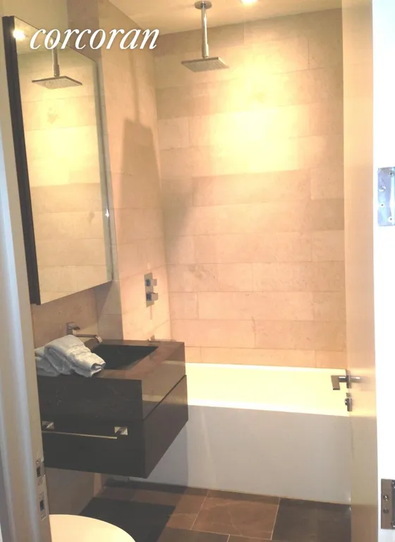 New York City Real Estate | View 140 West 22Nd Street, 3B | Chios brown mrbl sink,limestone flrs/walls,WET tub | View 3