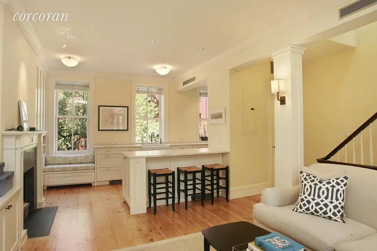 New York City Real Estate | View 4 Charles Street, 2 | Decorative fireplace next to breakfast bar | View 3