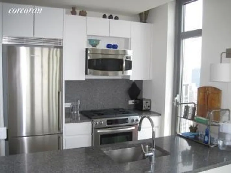 New York City Real Estate | View 105 West 29th Street, 46G | Open Granite Kitchen | View 2