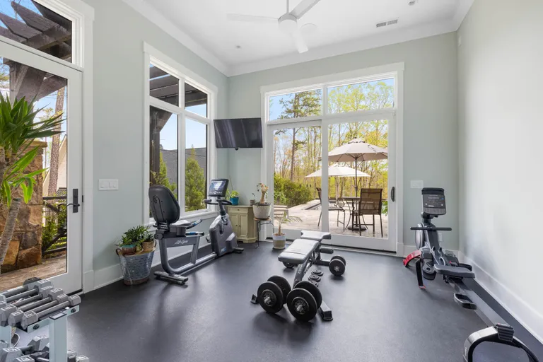 New York City Real Estate | View 7334 Lakeridge Drive | Home Gym off Primary Suite with Access to Outdoor Shower | View 24