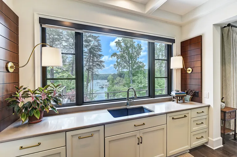 New York City Real Estate | View 125 Quiet Waters Drive | Kitchen Sink Overlooking Lake | View 7
